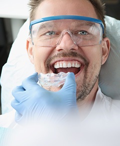 A male patient receiving a mouthguard from his dentist