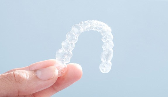 Patient holding clear aligner